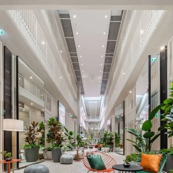 Luxurious modern building interior with elegant seating and lush greenery