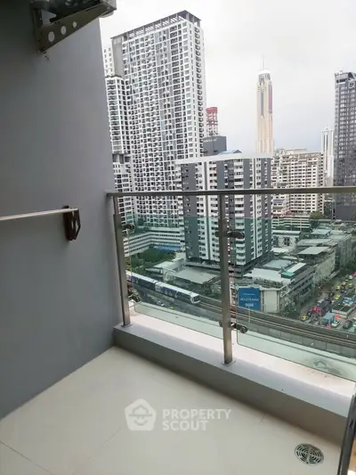 Modern balcony with city skyline view in high-rise apartment
