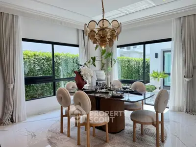 Elegant dining room with luxurious chandelier and garden view, perfect for sophisticated gatherings.