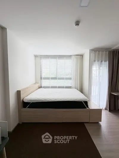 Modern bedroom with large window and minimalist design