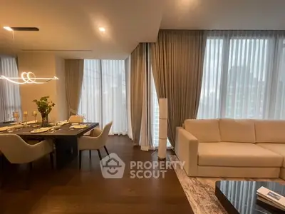 Luxurious living and dining area with elegant decor and floor-to-ceiling windows.