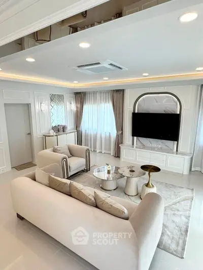 Luxurious living room with elegant decor, plush seating, and modern entertainment setup.