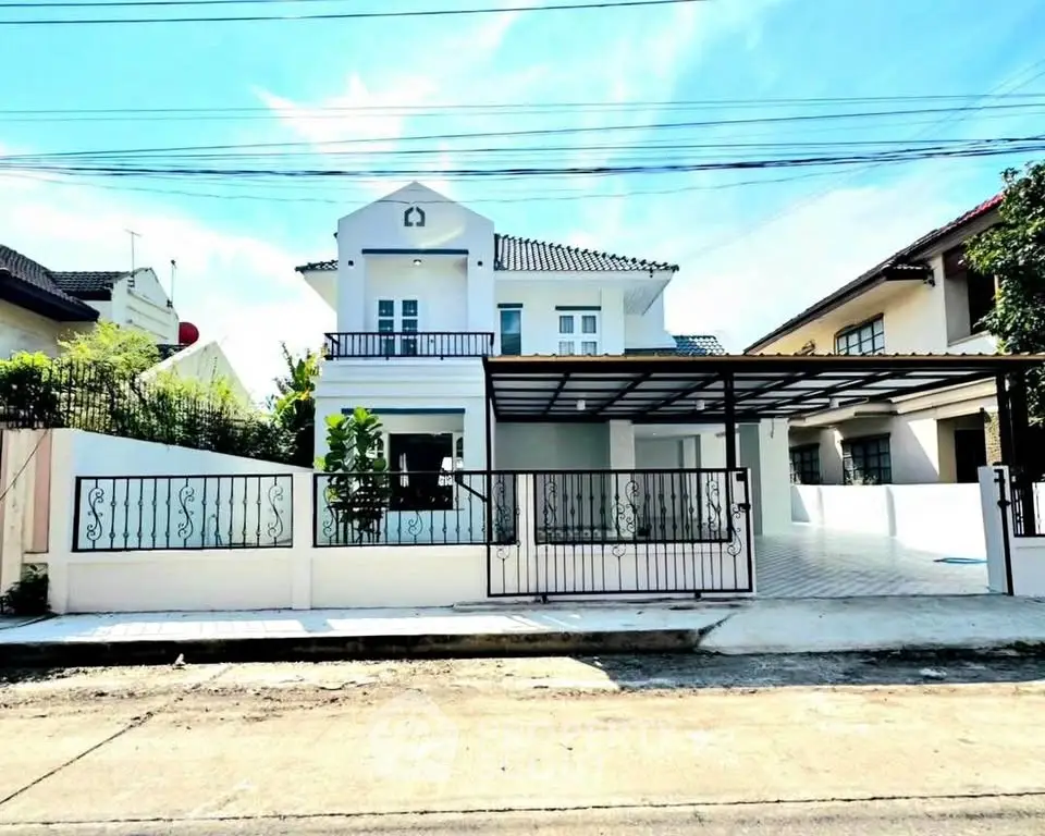 Charming two-story house with gated driveway and balcony in a serene neighborhood.