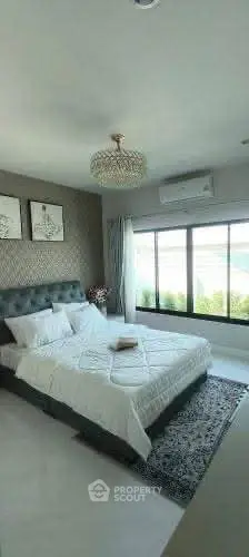 Elegant bedroom with large window and stylish decor