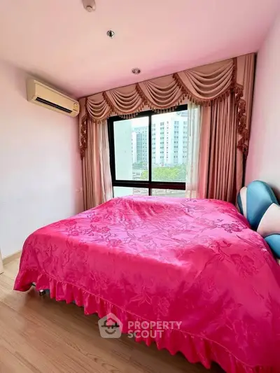 Charming bedroom with vibrant pink decor and city view, featuring elegant curtains and modern air conditioning.