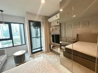 Modern bedroom with balcony view in high-rise apartment, featuring sleek furniture and ample natural light.