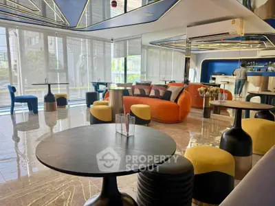 Modern living room with stylish furniture and large windows