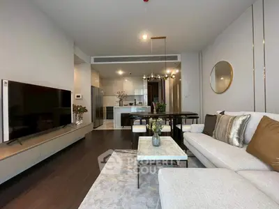 Modern living room with elegant decor and open kitchen layout in a stylish apartment.