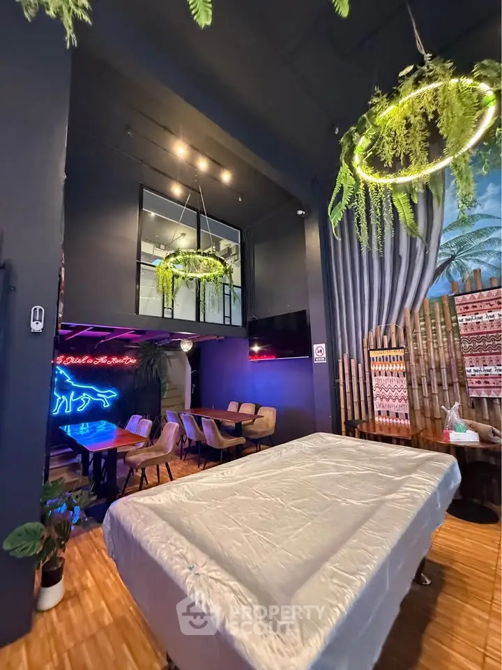 Stylish modern living area with pool table and neon lights, perfect for entertainment.