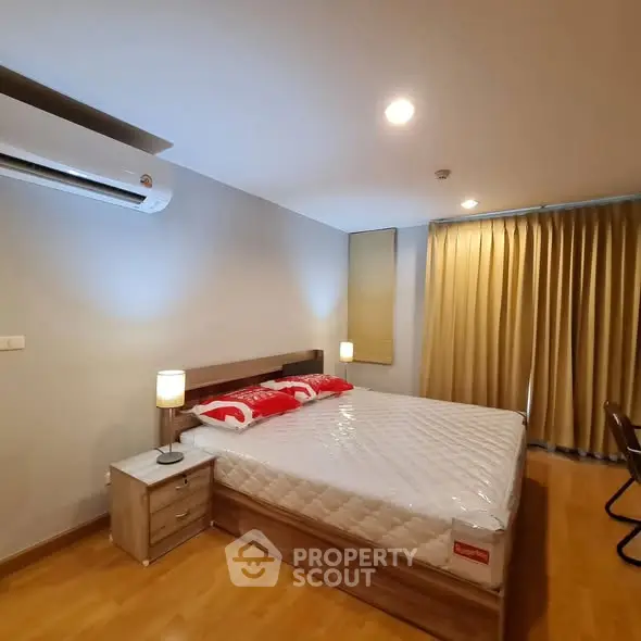 Cozy bedroom with modern furnishings and ample natural light