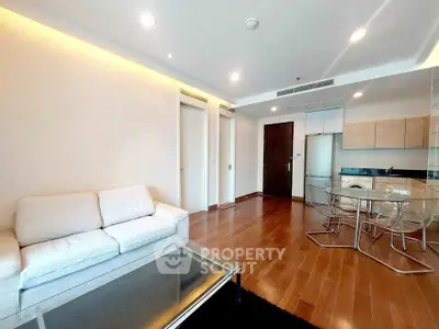 Spacious modern living room with open kitchen and elegant wooden flooring
