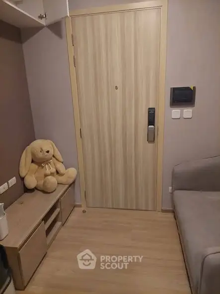 Cozy apartment entrance with plush toy and modern security features