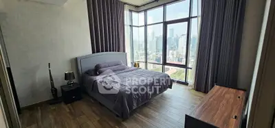 Luxurious bedroom with floor-to-ceiling windows offering stunning city views