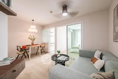 Modern living room with cozy sofa and dining area in stylish apartment