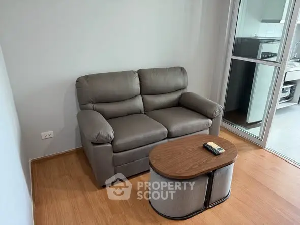 Cozy living room with plush sofa and modern coffee table, perfect for relaxation.