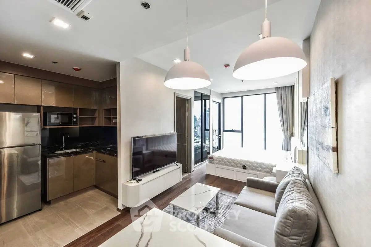 Modern open-plan living room with kitchen in luxury apartment, featuring sleek design and ample natural light.