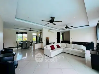 Spacious modern living room with elegant furniture and ceiling fans