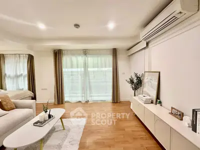 Spacious living room with modern decor and natural light