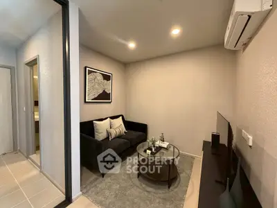 Cozy living room with modern decor and air conditioning, perfect for relaxation.