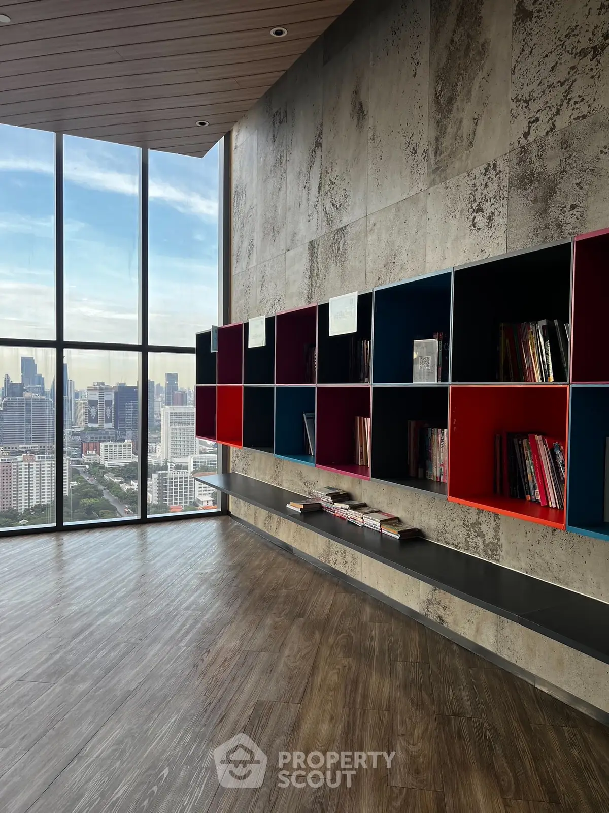 Modern library with panoramic city view and stylish shelving