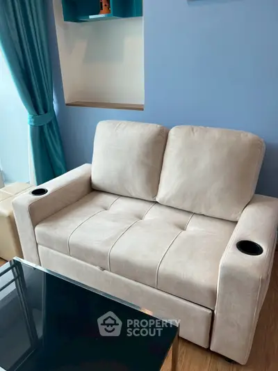 Modern living room with plush beige sofa and stylish blue accents