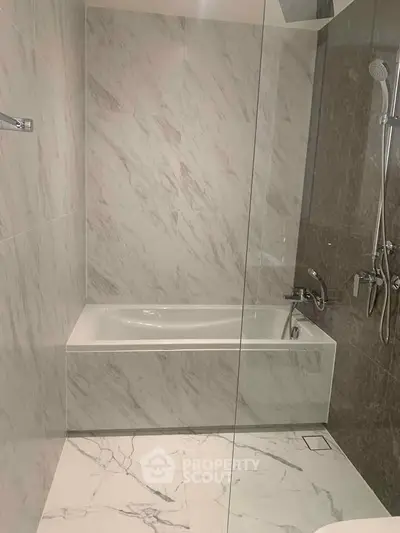 Luxurious marble bathroom with modern bathtub and shower fixtures