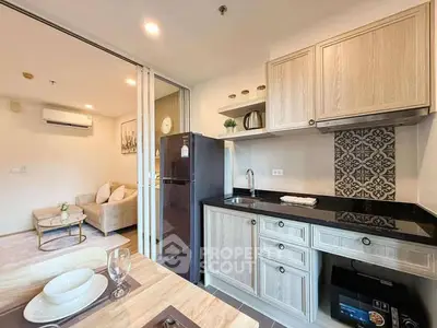 Modern kitchen with open layout and cozy living area in stylish apartment