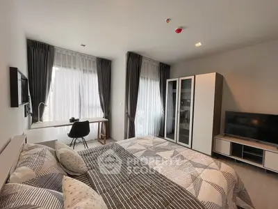Modern bedroom with stylish decor, large windows, and ample natural light.