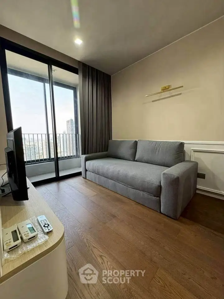 Modern living room with sleek sofa and city view balcony