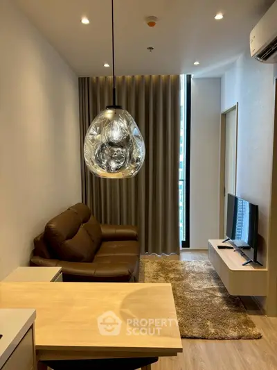 Modern living room with stylish pendant light and cozy brown sofa