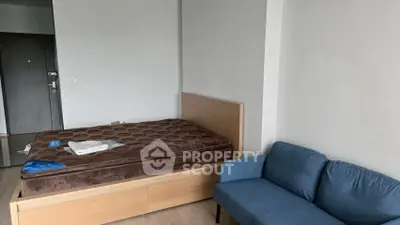 Cozy bedroom with modern furniture and a comfortable blue sofa