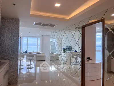 Luxurious modern living room with ocean view and elegant mirrored walls