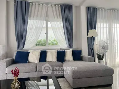 Elegant living room with modern gray sectional sofa and blue accents
