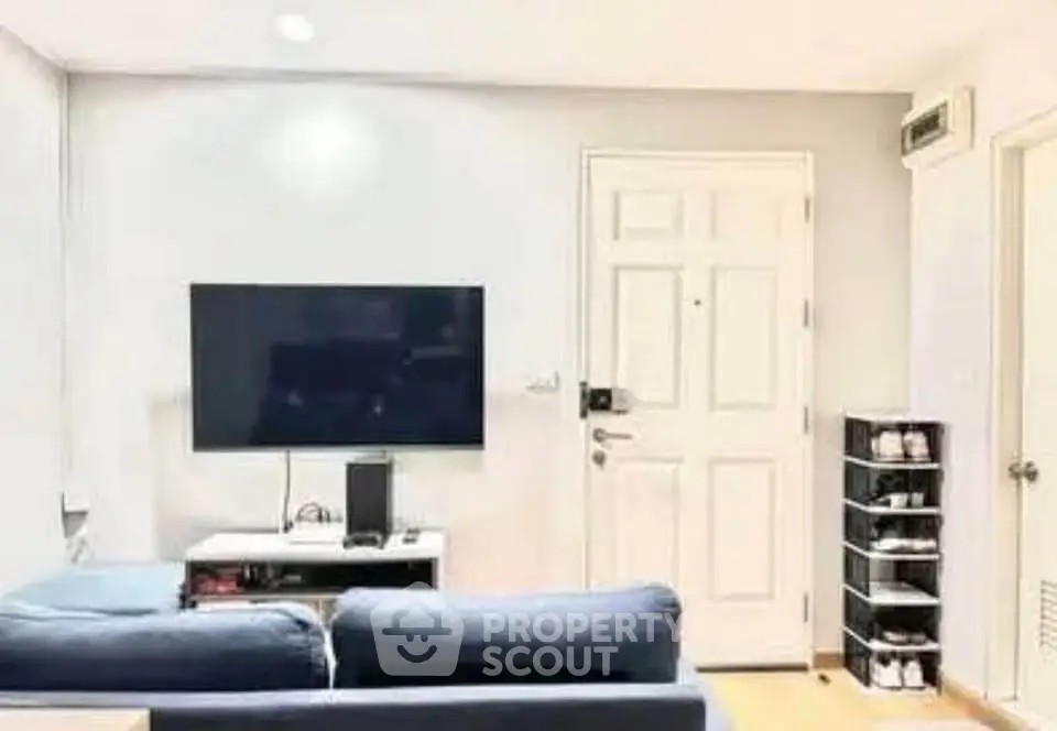 Modern living room with sleek TV setup and cozy seating area