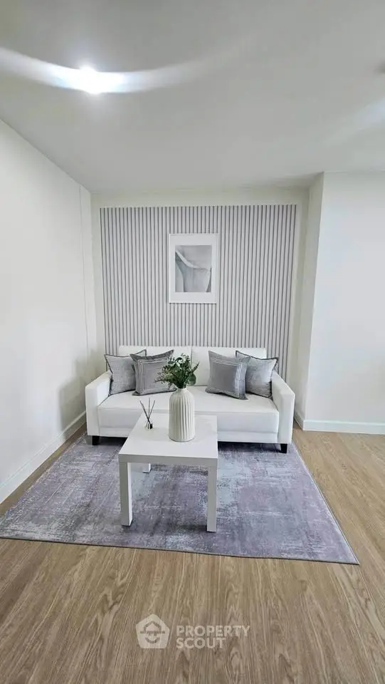 Modern living room with stylish decor and cozy seating area, perfect for relaxation.