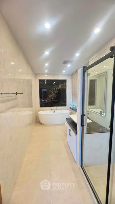 Luxurious bathroom with elegant bathtub and modern glass shower enclosure