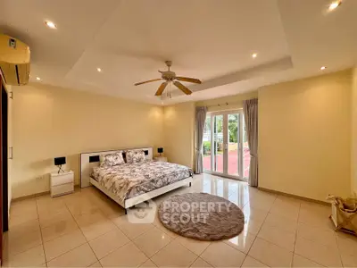 Spacious bedroom with modern decor and garden view