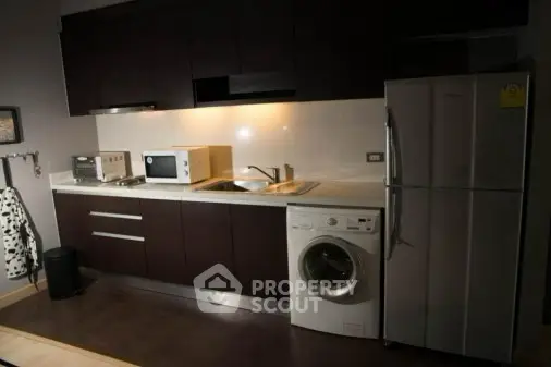 Modern kitchen with sleek appliances and dark cabinetry