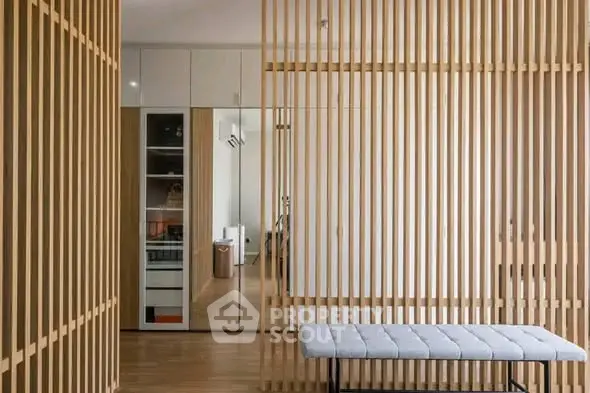 Modern interior with wooden slat partition and stylish bench in a contemporary home.