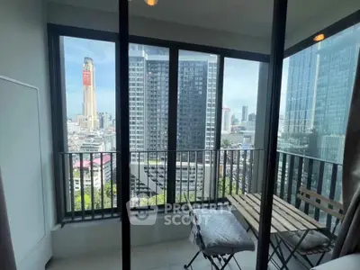 Stunning city view from a modern balcony with cozy seating area, perfect for relaxation.