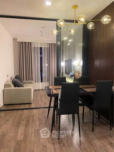 Modern living and dining area with elegant lighting and stylish decor