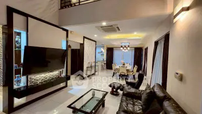 Luxurious open-concept living and dining area with modern furnishings and elegant lighting.