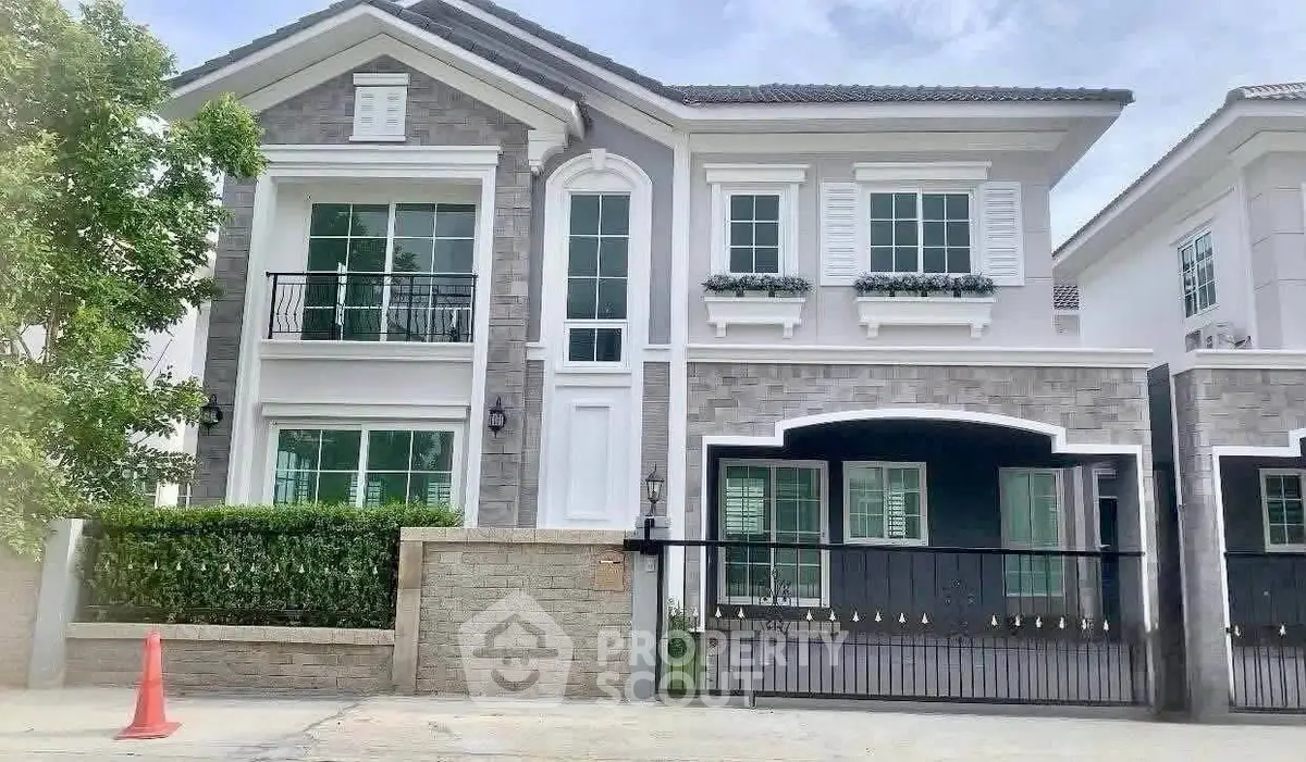 Elegant two-story house with modern facade and lush greenery in a serene neighborhood.