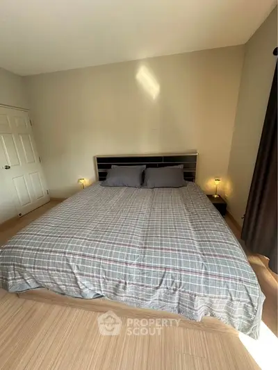 Cozy bedroom with stylish bedding and soft lighting, perfect for relaxation.