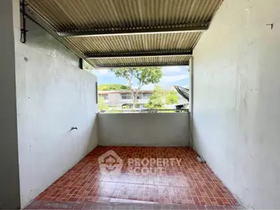 Covered outdoor area with tiled floor and open view, ideal for versatile use.