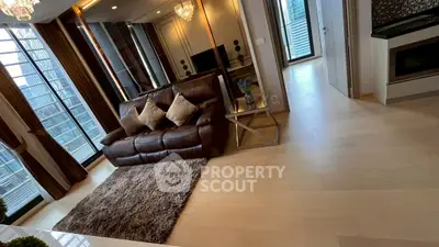 Luxurious modern living room with city view, elegant decor, and plush seating in high-rise apartment.