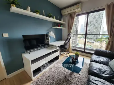 Modern living room with city view, featuring sleek furniture and stylish decor.