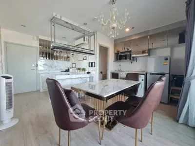 Luxurious modern kitchen with marble countertops and elegant dining area in high-end apartment.