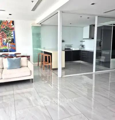 Spacious modern living room with open kitchen and sleek tile flooring