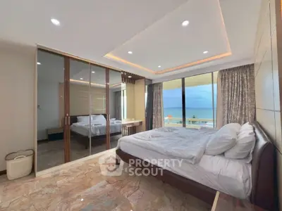 Luxurious bedroom with ocean view and mirrored closet doors